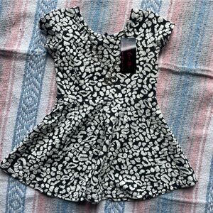 Abstract black and white dress with heart shaped necklace